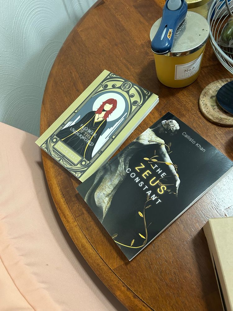 photo of The Zeus Constant by Callisto Khan, and Flower of the Underworld by Cirice Grey