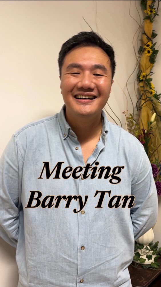 Barry Tan, renowned pianist, smiling, with a caption that reads: Meeting Barry Tan. He is wearing a blue sweater and looks goofy and cute. Behind his left shoulder is a flower decoration. The linked video includes an interview and performance clip. 