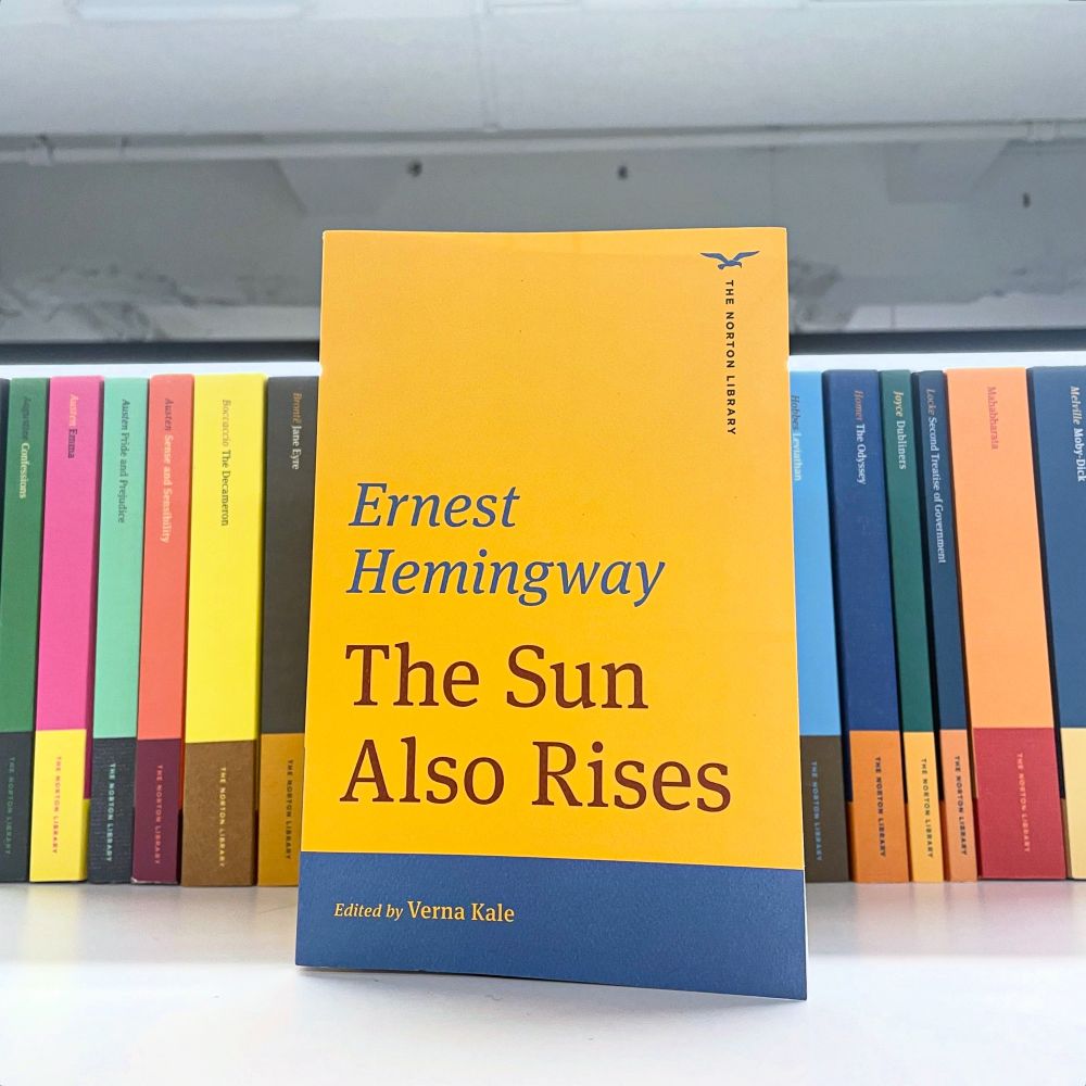 Copy of Hemingway’s The Sun Also Rises Norton Library edition against a backdrop of other Norton Library titles  