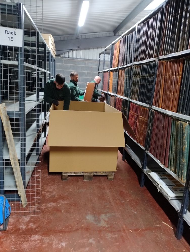 Stephen, Jay and Dan from DeepStore removing Rate Books from shelves at the Oldham Archives off-site store and packing them into a giant box on a pallet. When I was cleaning these volumes earlier this year, the work was powered by swearing.