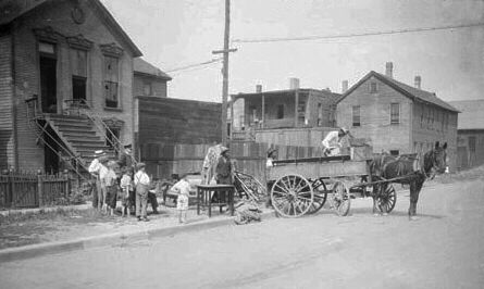 Photo of Black Chicago residents loading  possessions into a wagon as they leave home destroyed by white rioters.
