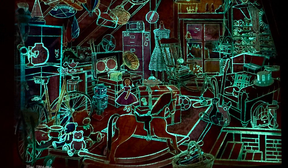 A glow in the dark puzzle that shows a rocking horse, a chair, dishes, and many other things that are lit up with the color green