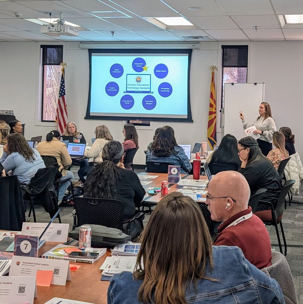A presenter at the front of the room showing a slide about the Arizona EdTech Standards. 