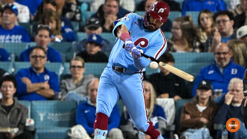A photo of Kyle Schwarber hitting a baseball.