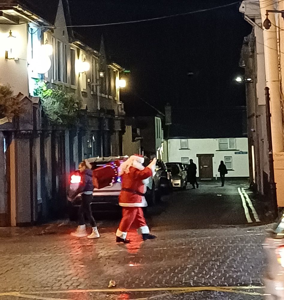 Santa lookalike walking on a footpath and waving