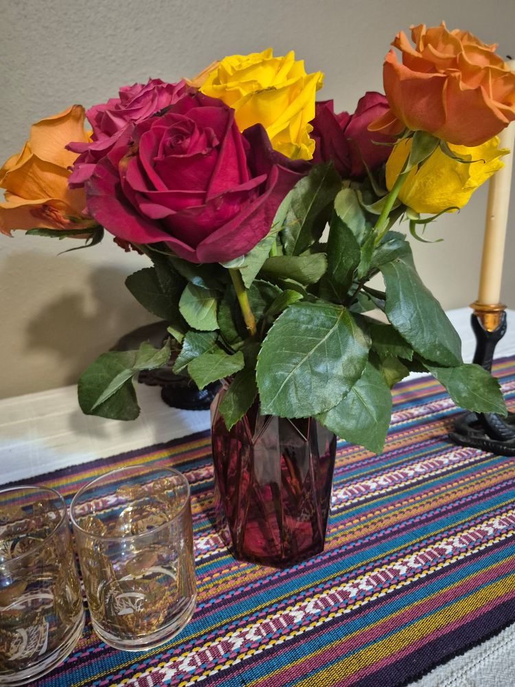 Rose bouquet in a red glass vase