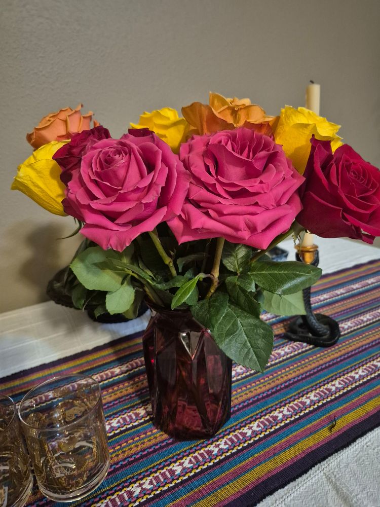 Rose bouquet in a red glass vase