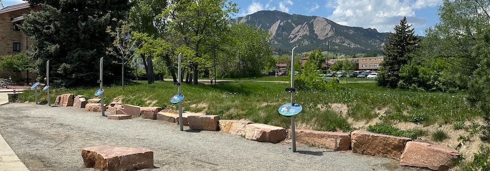 A scale model of the planets with the Colorado mountains in the background