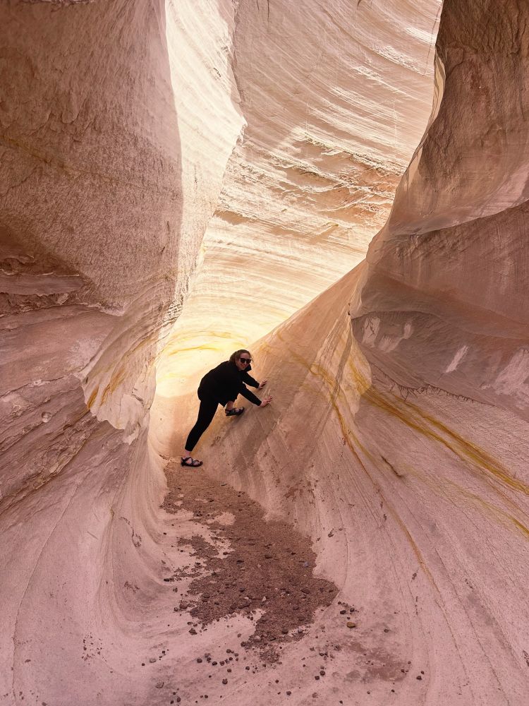 marisa appears to try to climb a wall of white sandstone, like a goof