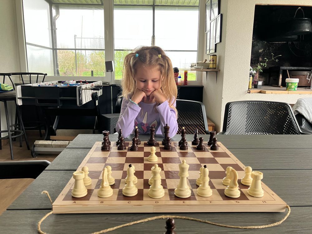Little girl playing chess.