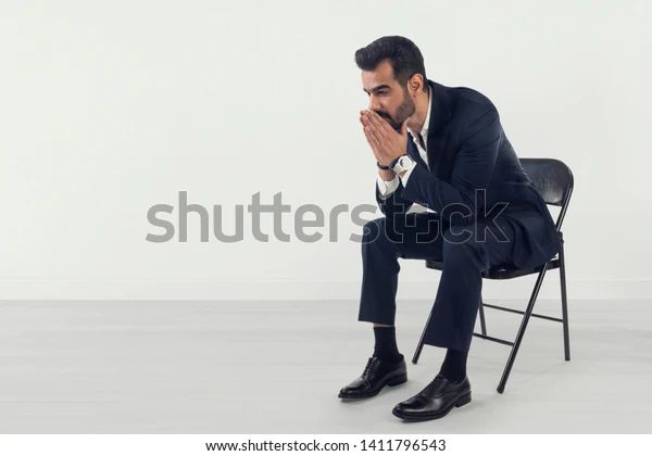 Businessman feeling worried and stressed, applicant sitting in waiting room, Worried businessman feeling stressed. shutterstock image. 