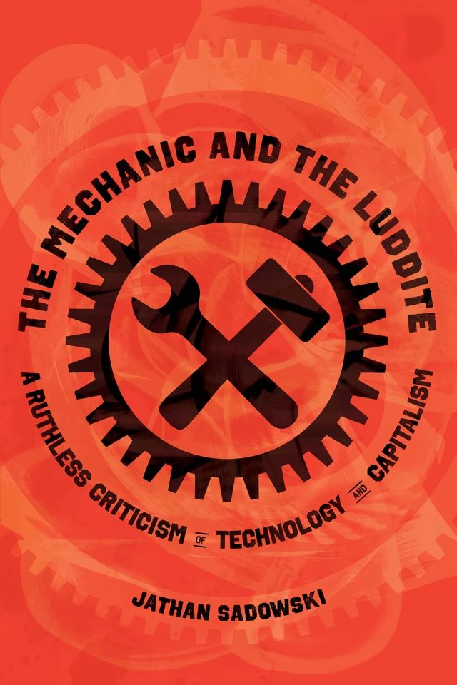 Screenshot of the book cover for "The Mechanic and The Luddite: A Ruthless Criticism of Technology and Capitalism by Jathan Sadowski." The book cover is a bright, firey orange which features a wrench and hammer crossed in the centre and framed by a circular toothed gear.