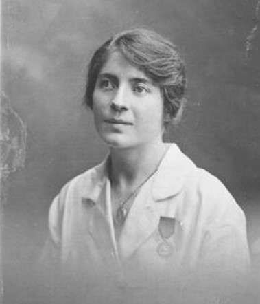Euphemia Cunningham in a white overall wearing her Medal of Order of British Empire - B&W headshot
