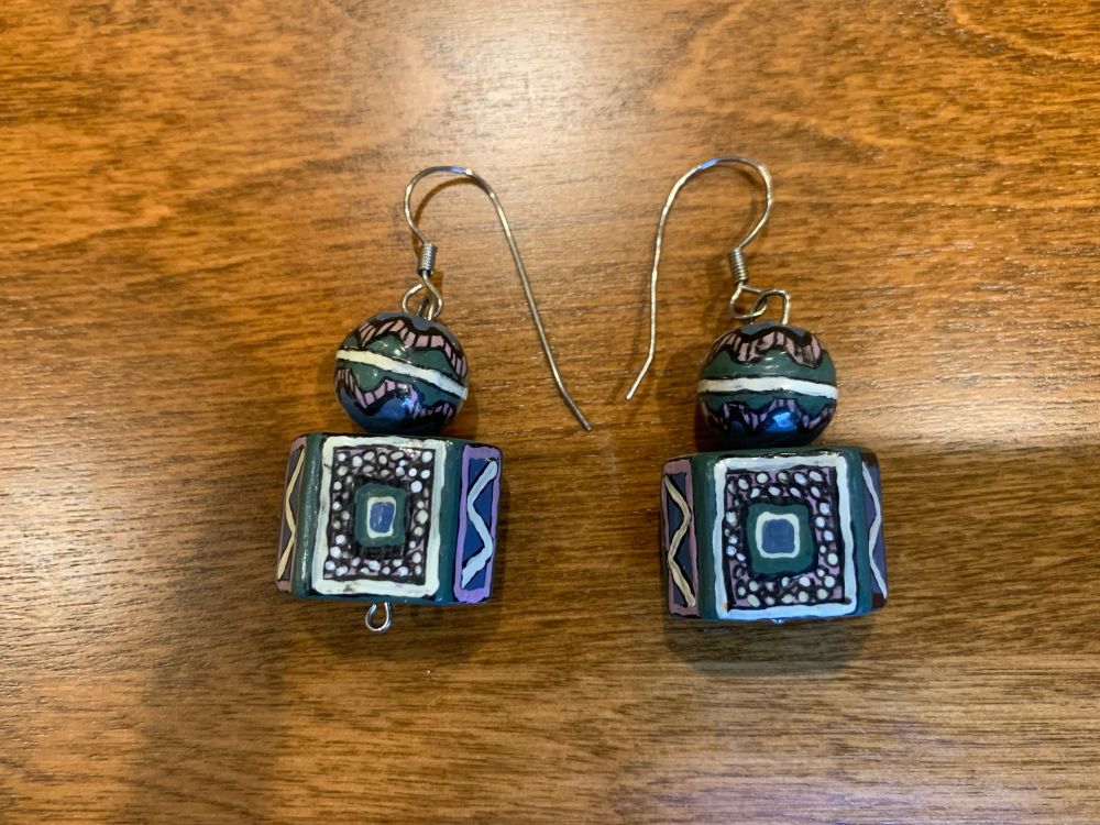 Blue, violet, green and white patterned beads made into earrings 