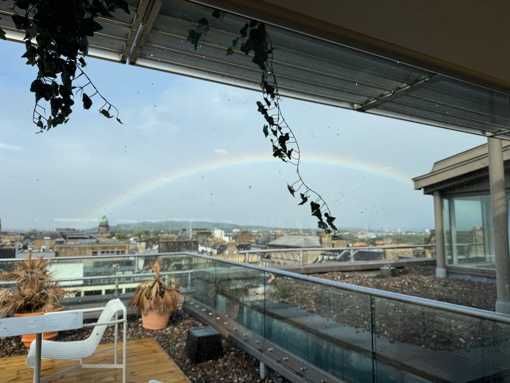 Rainbow over city rooftop