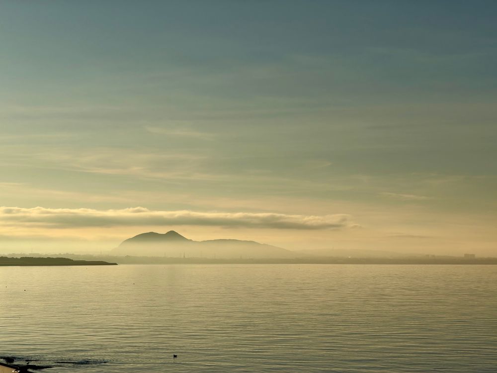 Layers of fog over the Forth, mountains in distance, winter sky. 