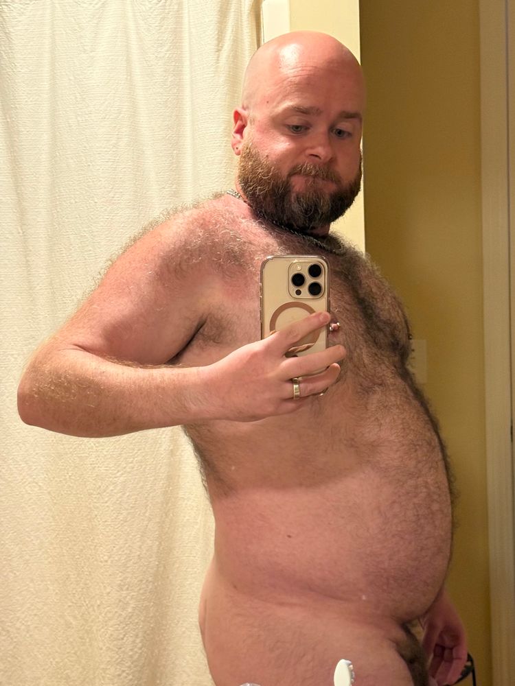 A nude photo of me in the mirror, from the side. My hairy shoulder and upper arm are both a bit red from the sun. 