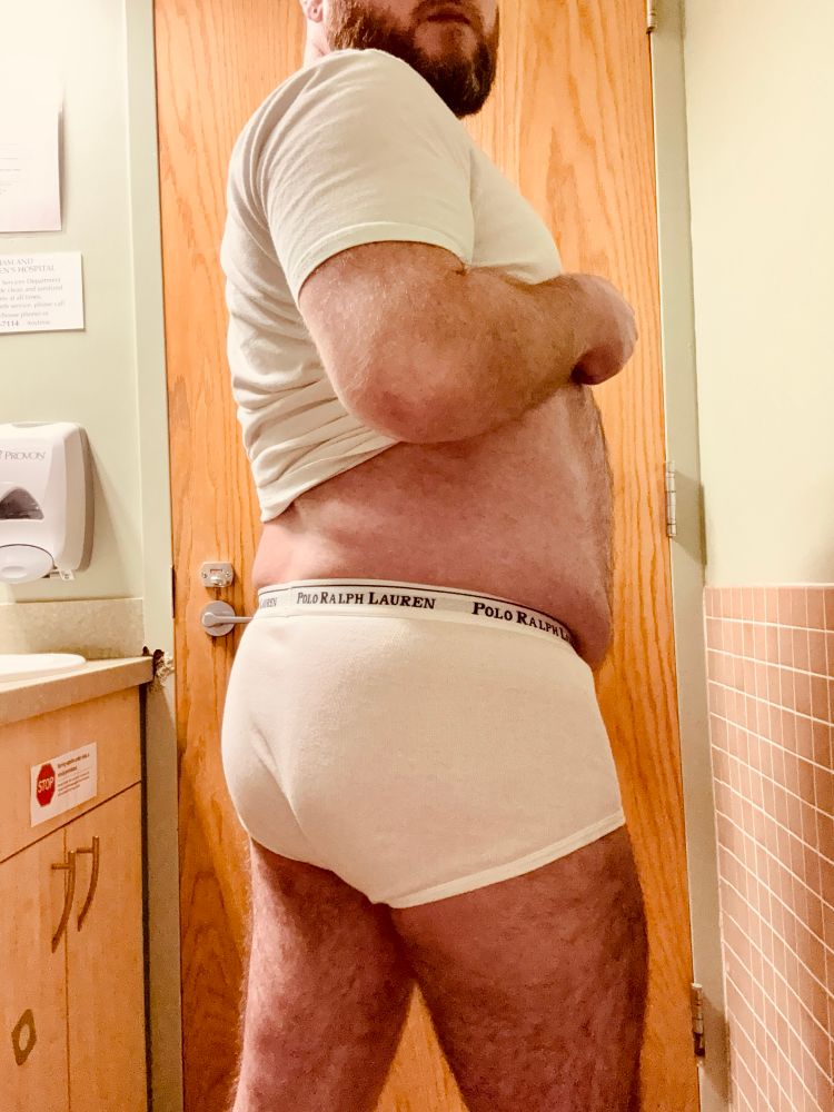 Me from behind in the same tee and briefs, the cotton hugging my beefy butt. The waistband comes up a bit high on me, and the legs are cut pretty low, giving the briefs almost a square silhouette.