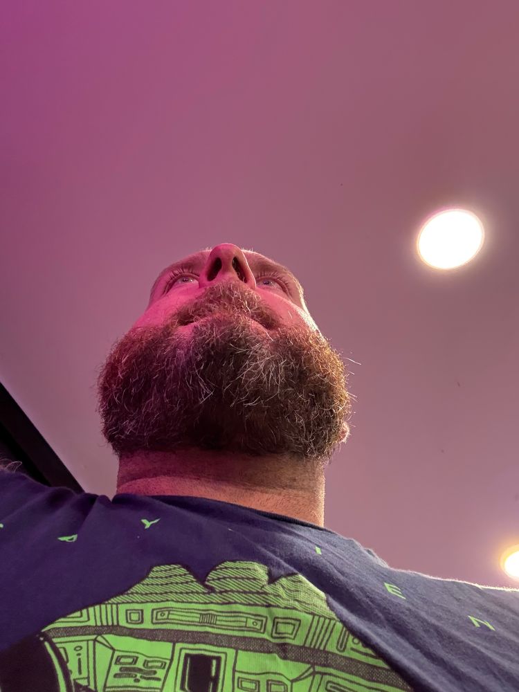 A photo of me taken from under my chin. I’m in a brightly lit pizza parlor in Ptown, late at night after partying