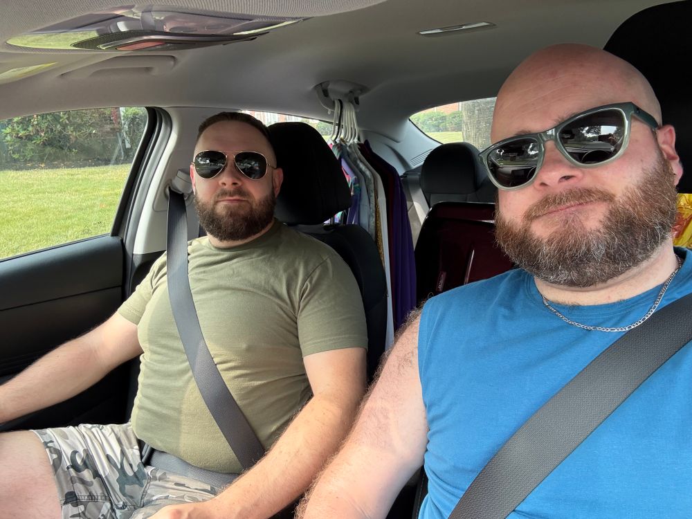 Me and my husband in the car on our way to Ptown for Bear Week. I’m in a blue sleeveless T and teal sunglasses, he’s in a green T with grey camo shorts. (I’m wearing shorts too, you just can’t see them)