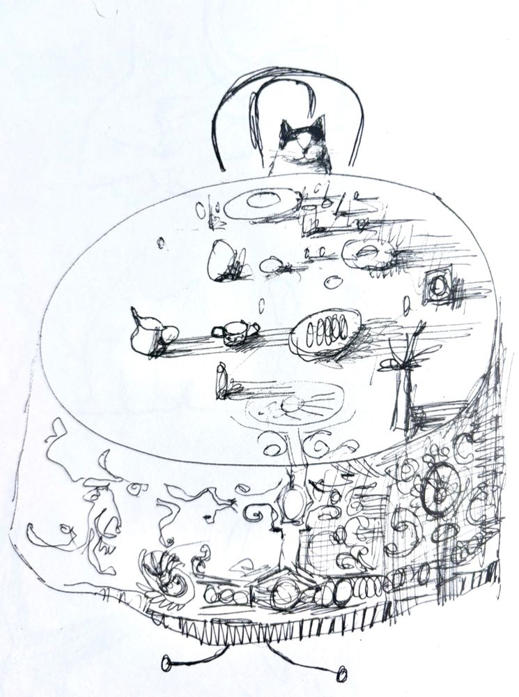 Black & white drawing of a cat seated alone at a big round table full of plates, cups, utensils and other items. He's looking at us.