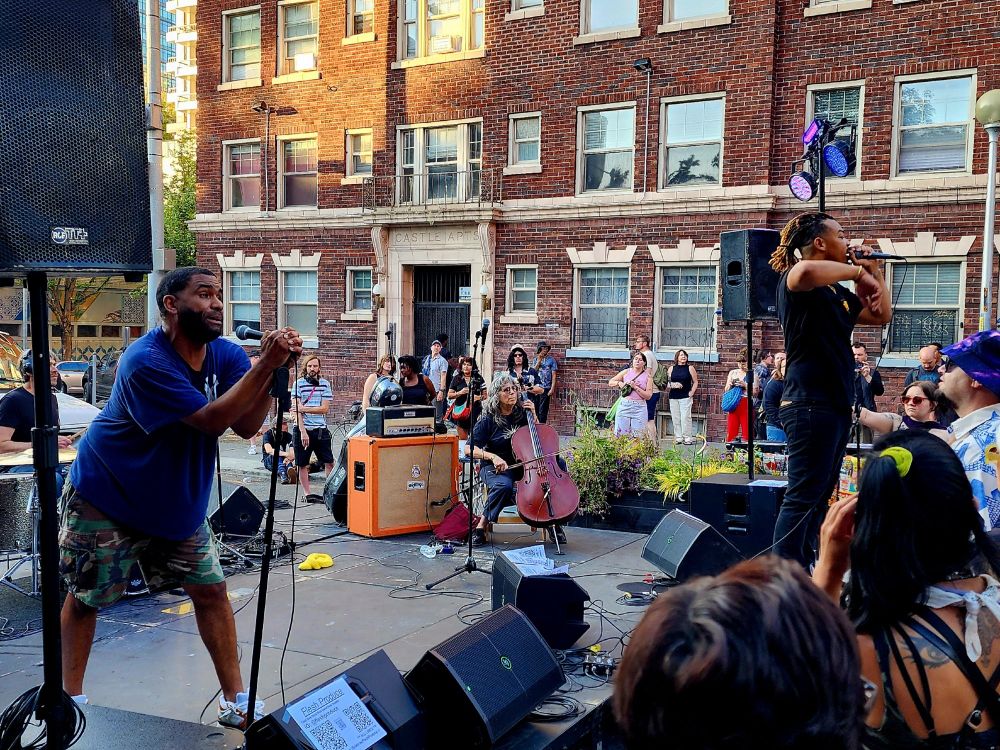 Lil Lebowski on the Jupiter Stage at Belltown Blast in Belltown, Seattle. Lori Goldston in the back guesting on Cello for their set.