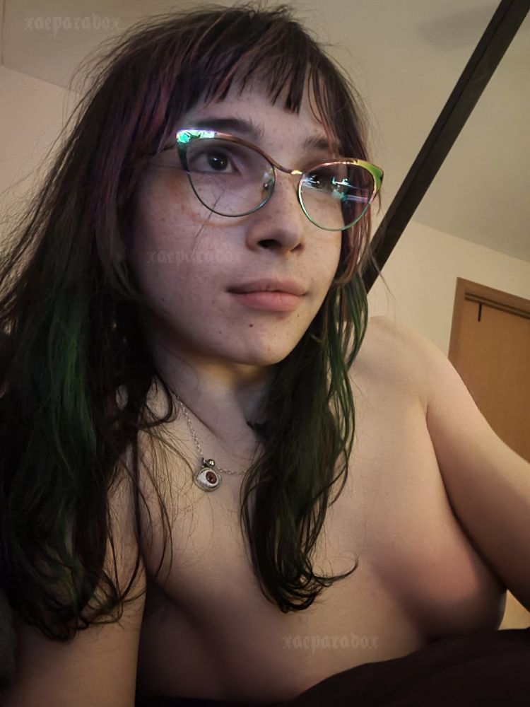 Xae Paradox laying in bed topless