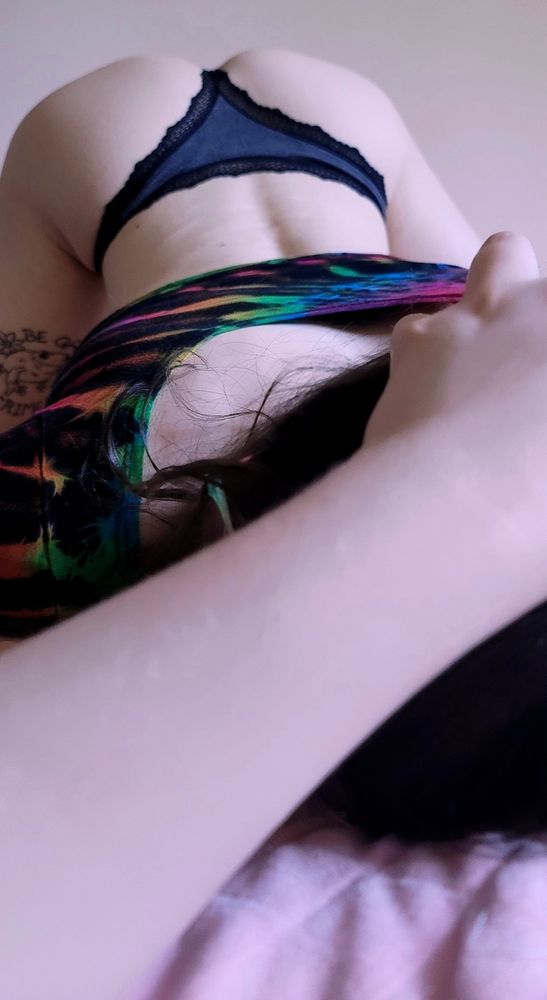 Xae is pictured face down ass up with her head towards the camera. Her head is being pushed into the bed by Rainbow's hand, and you have a clear view of her pretty arch in a pair of lacey panties