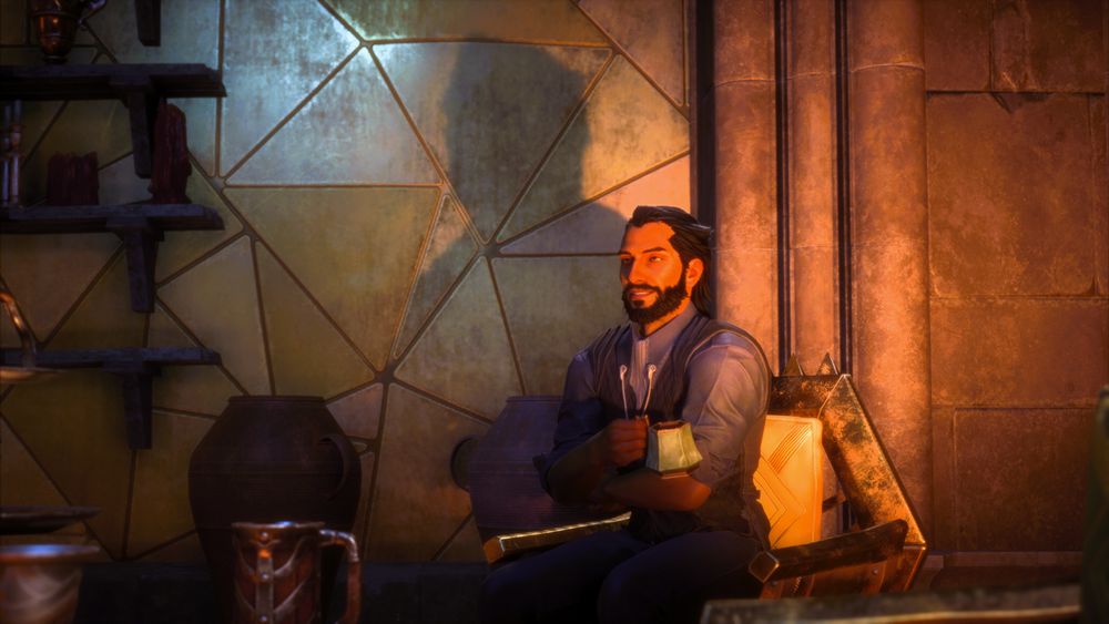 Lucanis Dellamorte sitting in the dining hall of the Lighthouse.  He is sitting forward in his chair and smiling as he looks up at someone.  His arms are folded and he's holding a cup of coffee.