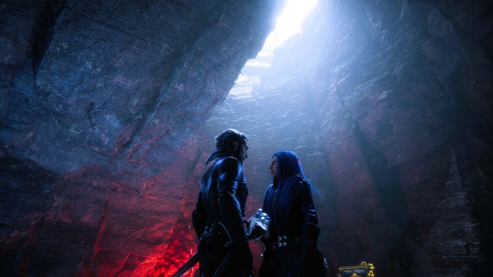 Lucanis Dellamorte and Amelia de Riva standing in a cave.  There is a a gap in the ceiling of the cave, and light is shining down on them.