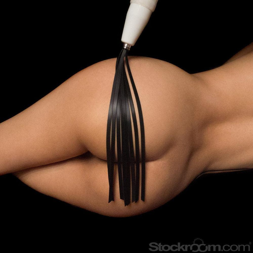 A person's bare butt against a black background, with rubber falls from a flogger attachment connected to the Neon Wand electrostimulation toy. 