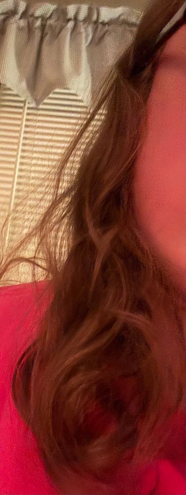 Dark blonde hair with a very loose wave 