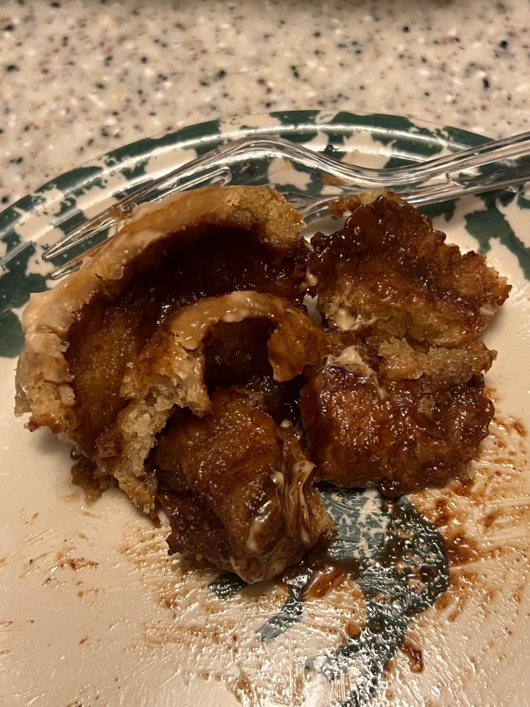 The inside of a cinnamon roll showing the layers of soft dough and cinnamon 