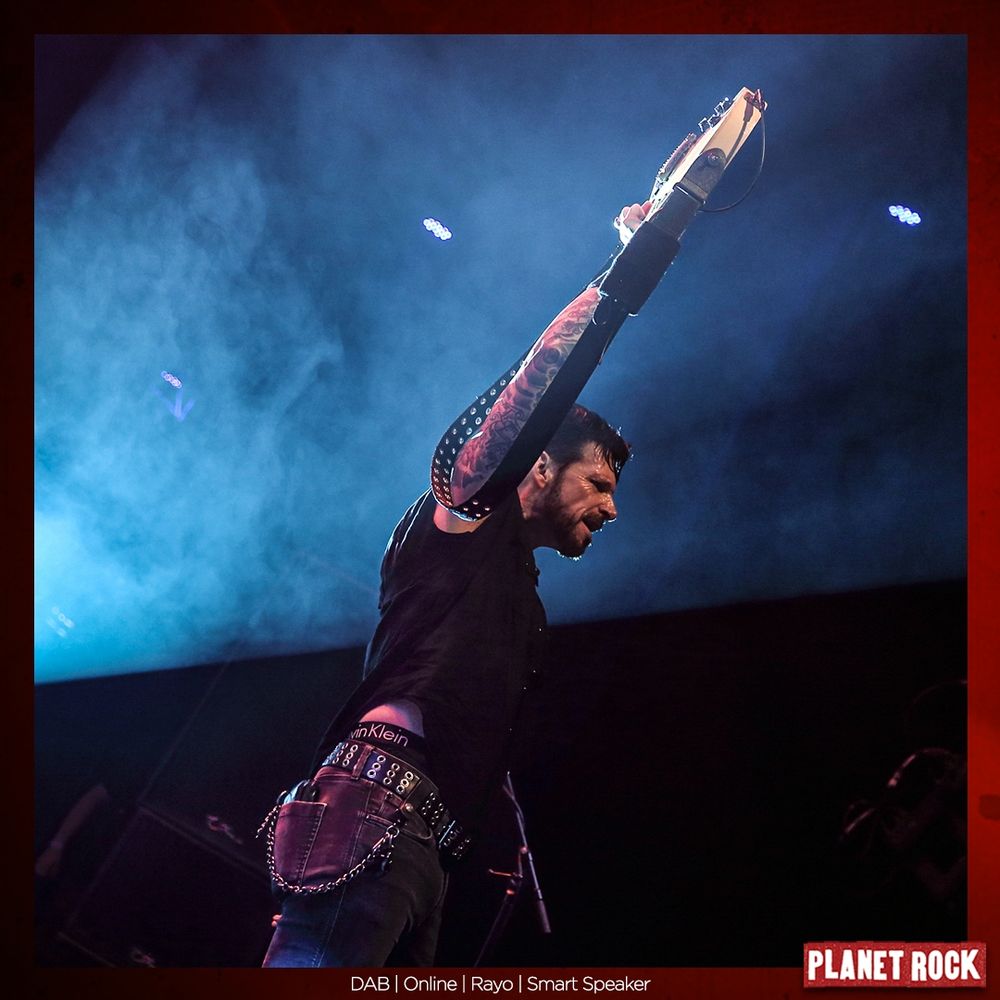 Ricky Warwick holds his guitar aloft