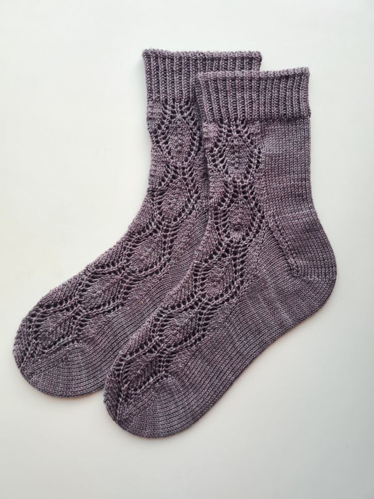 Handknitted socks with a lace pattern