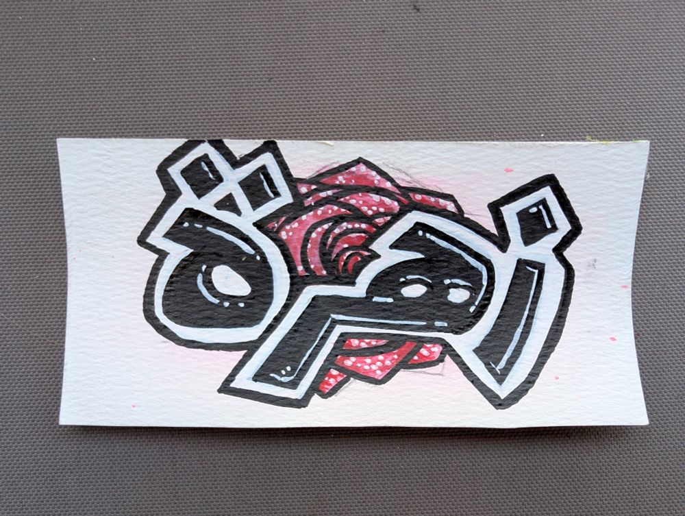 A graffiti style tag of a rose, with the Arabic word "Zahra" written overtop with a thick white and black outline, visually separating the two elements.