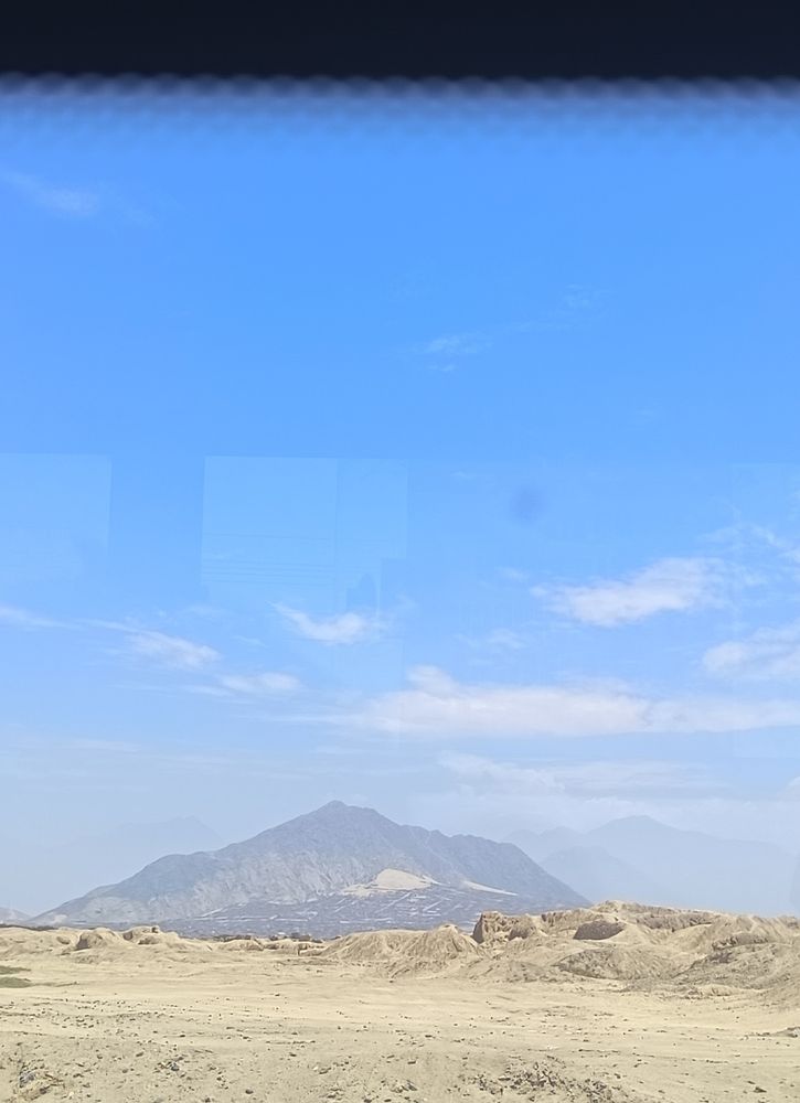 The currently unexcavated side of the ancient adobe city of Chan Chan with the hills of Trujillo beyond. 