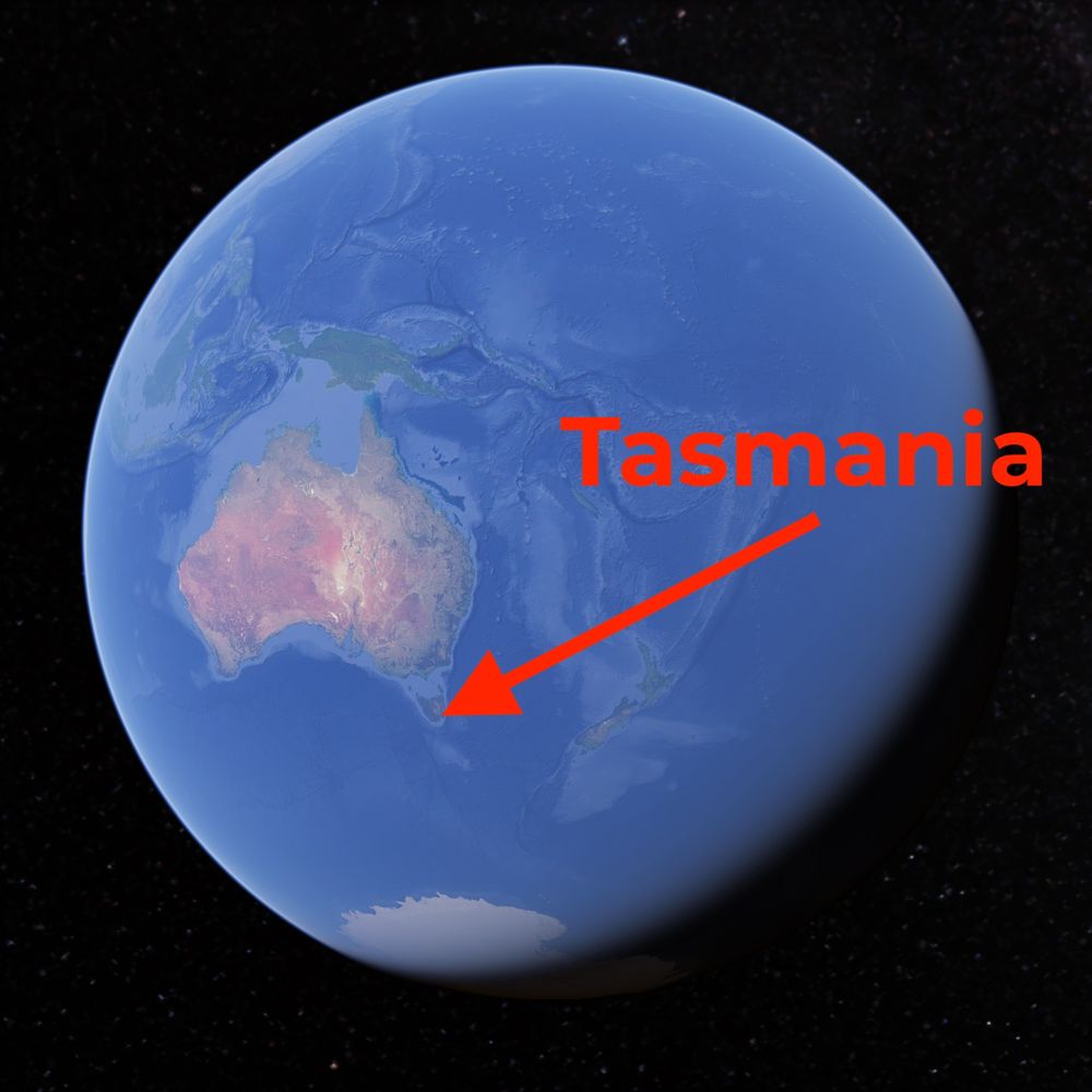 A picture of the globe from Google Earth has been positioned such that the centre of the frame is on Australia. An arrow has been drawn to the tiny island state hanging off the bottom of Australia, which is labelled Tasmania.