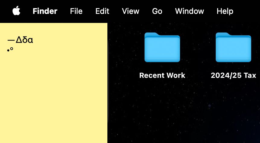 screenshot of a tiny upper-left corner of a macOS desktop shows a few folders called Recent Work, 2024-2025 Tax, and a sticky note using the inbuilt Stickies app which adds persistent paste-able text fields to the desktop which look like sticky notes. This one shows a bank of unicode symbols to presumable copy-paste from for use in documents: an em-dash, bullet, degrees symbol, a few greek letters.