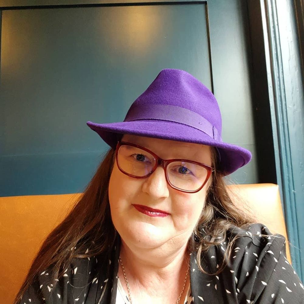 Picture of Theresa with her trademark purple fedora