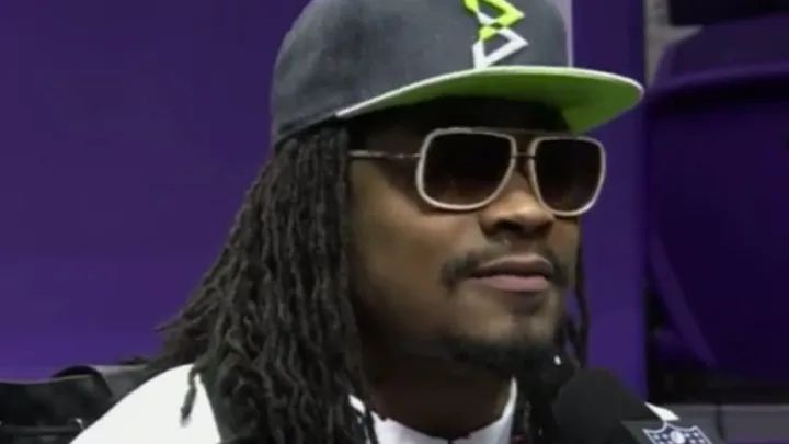 professional football player Marshawn Lynch at a press conference where he famously answered "I'm only here so I don't get fined" to every question.