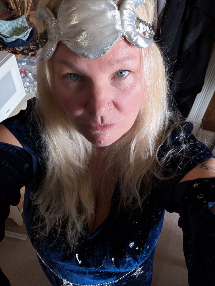 Another view of the blue velvet dress with silver stars and moons, this time without the purple cloak. You can see the cut outs in the sleeves near the shoulders. And a thin silver beaded belt with silver stars around my waist. 