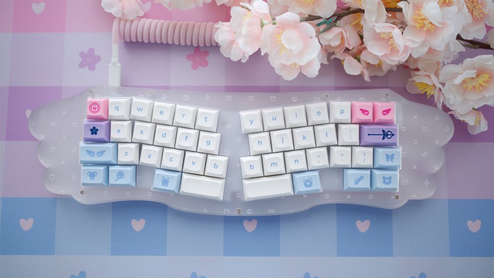 Wing keyboard with Bisexual color themed keycaps and deskmat.