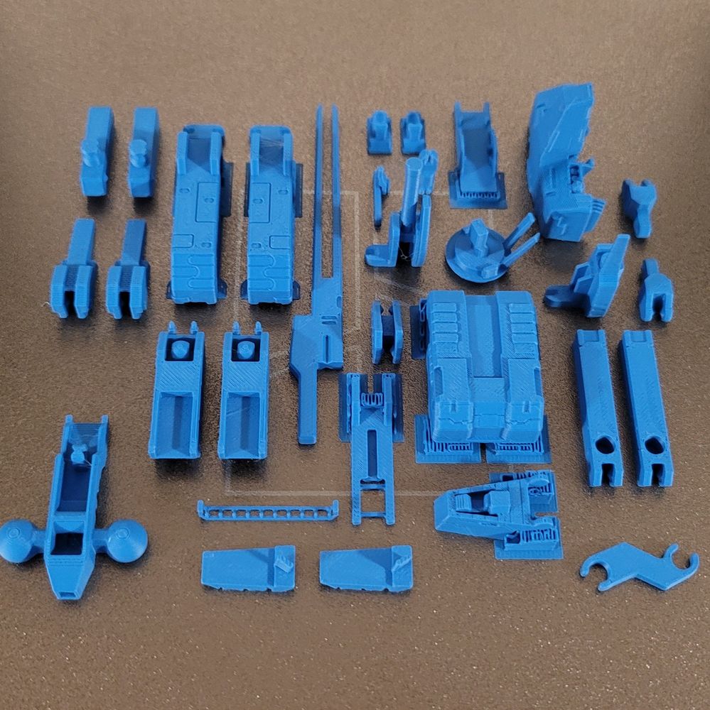 An unassembled 3d printed Metal Gear Rex on a printing plate