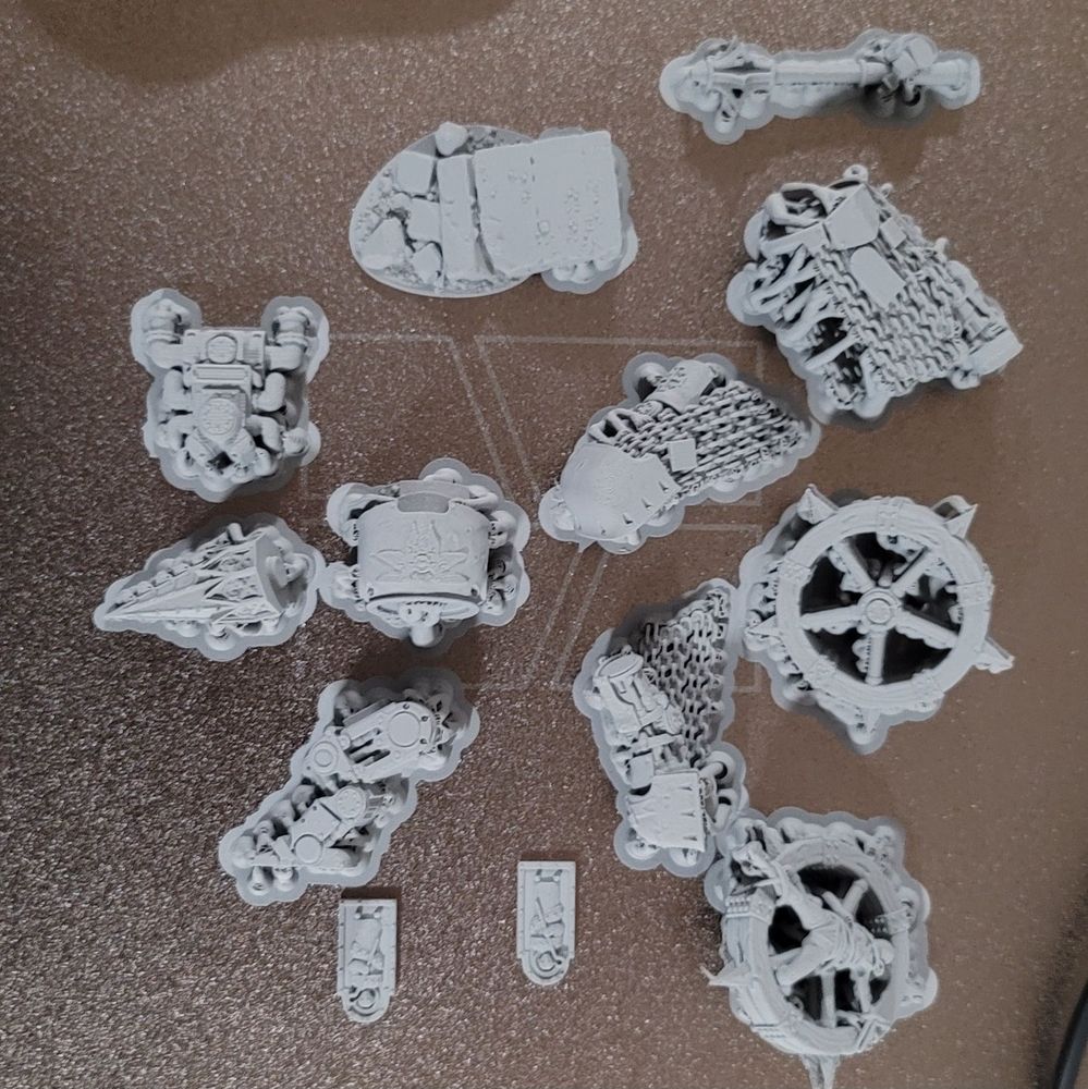 3d printed pieces for a Shrine Anchorite on a textured metal printing plate.