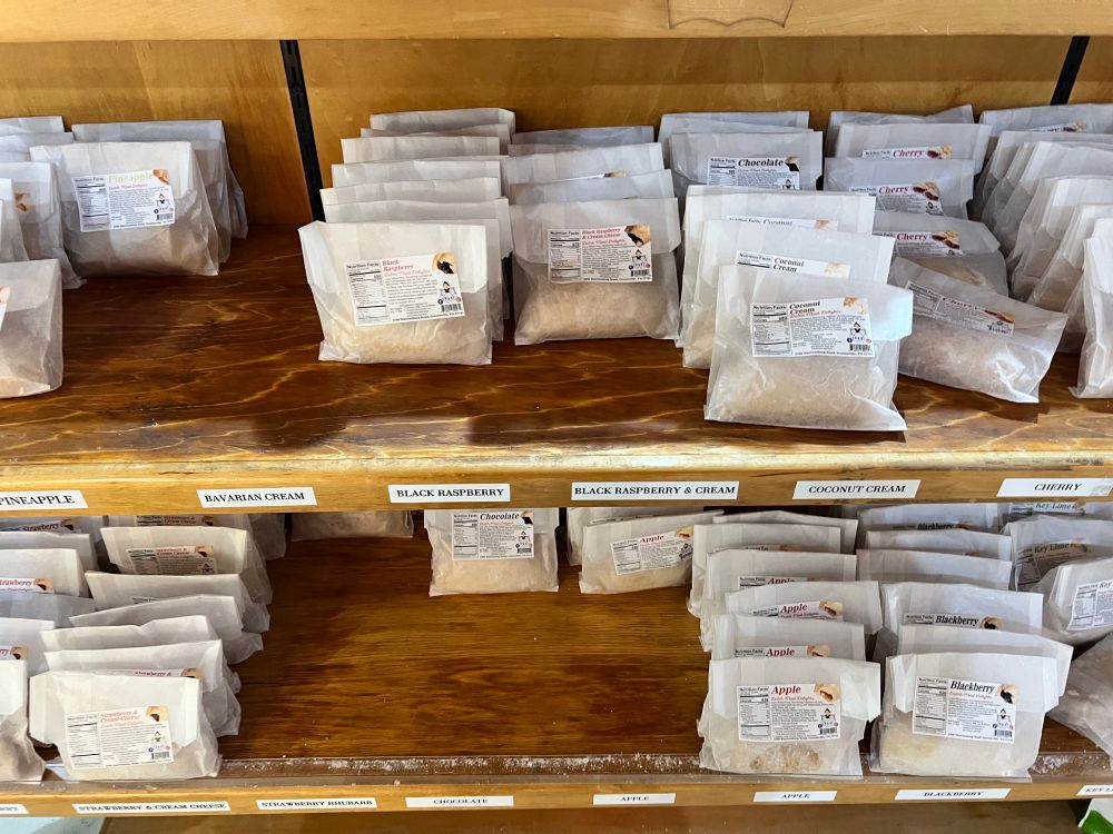 Assorted Fried Pies on a wooden shelf. 