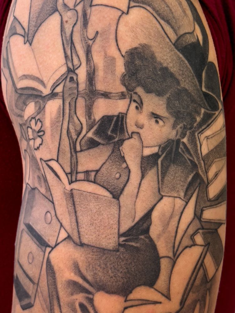 A tattoo depicting a witch surrounded by floating books.