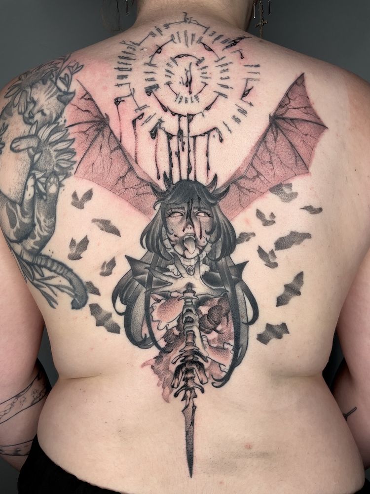 A tattoo depicting a vampire wielding a dagger. Sinew is visible underneath the vampire’s torso.