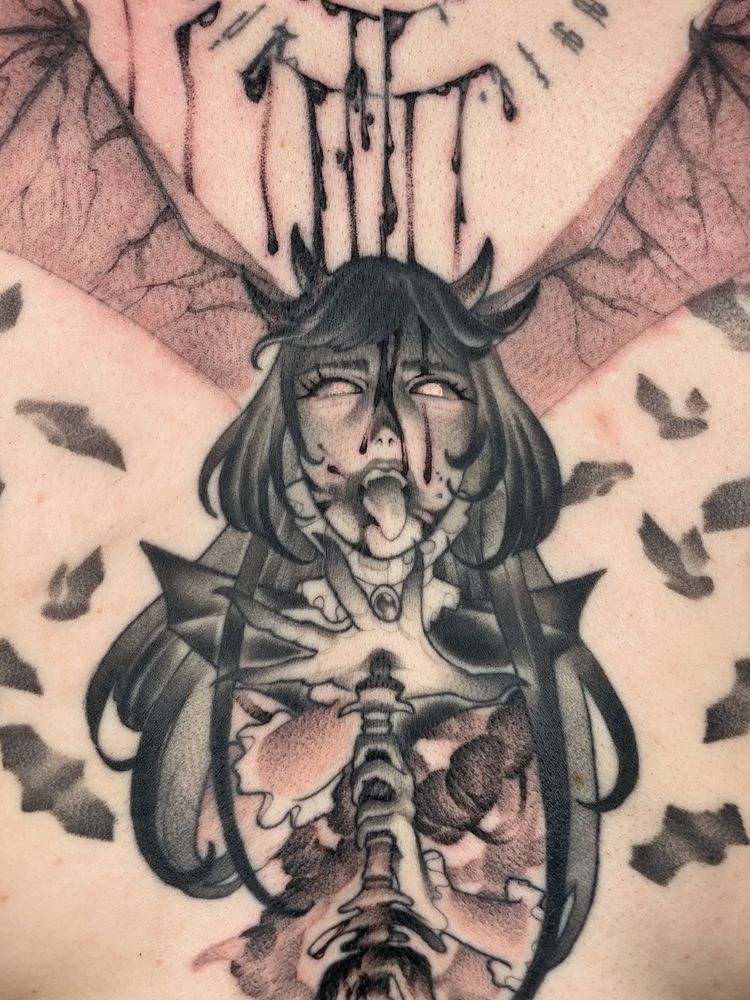 A tattoo depicting a vampire wielding a dagger. Sinew is visible underneath the vampire’s torso.