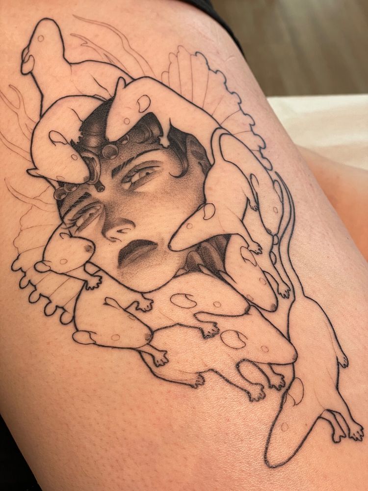 A tattoo depicting the portrait of a queen surrounded by rats.